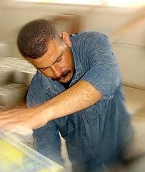 Man in a denim shirt working.