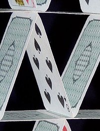 Playing cards stood on top of each other.